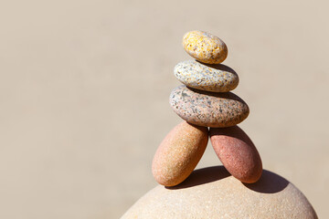 Rock zen pyramid of white, red and yellow stones. Concept of balance, harmony and meditation