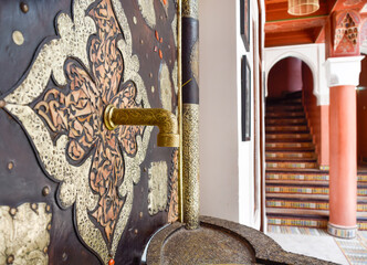 Faucet and fountain with Arabic stairs in background. Typical Marrakech courtyard
