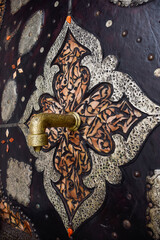 Faucet and fountain with Arabic stairs in background. Typical Marrakech courtyard