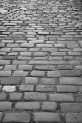 Old cobblestone sidewalk, pavement isolated on white, perspective view. Top view on paving stone road. Old pavement of granite texture. Street cobblestone sidewalk. Abstract background for design.