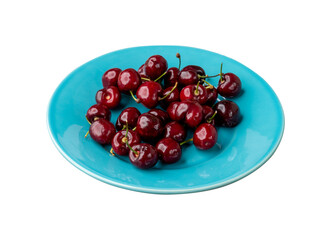 Red cherries on a plate isolated over white background