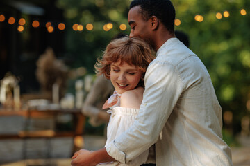 Fototapeta premium Cute redhead dancing in the loving embrace of her boyfriend