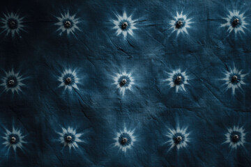 Fototapeta premium Indigo dyed fabric with white sunburst patterns arranged in rows, creating textured and artistic textile design with natural and handcrafted feel