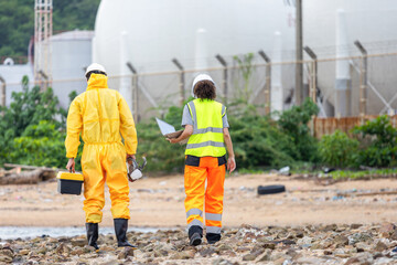Environmental Workers Inspecting Industrial Site, Team in Protective Gear Surveying Contaminated...