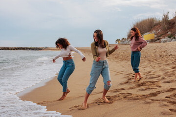 Three friends having fun by ocean