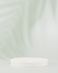 White round empty podium for presentation, advertising or montage your products on soft blue background with palm leaf shadow. Concept of scene stage for natural products or promotion sale