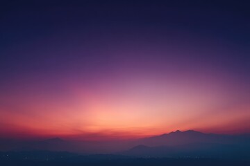 Sunset over hazy mountains