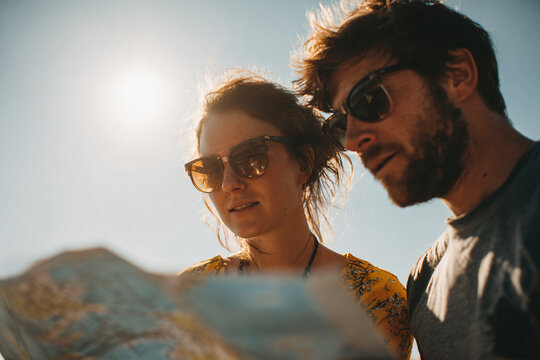 a man and woman looking at a map