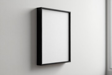 Black framed, blank canvas on a white wall