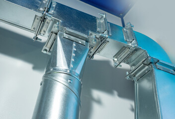 Metal industrial air duct system with connectors and supports, designed for ventilation and air distribution in HVAC installations. – Industrial equipment. Air ventilation.