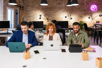 Multi ethnic team working together on project in modern office