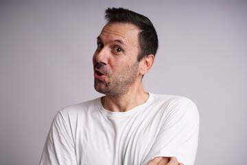 Fototapeta premium Male Model Showing Different Emotions on White Studio Background