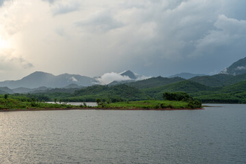 Misty Hills over a Tropical Lake at Dusk