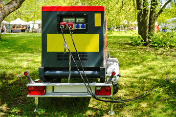 Industrial generator on trailer parked in forest. Providing electricity for events.