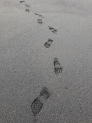 footprints on the surface of the beach sand