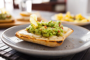 Morning toast with melted cheese and guacamole