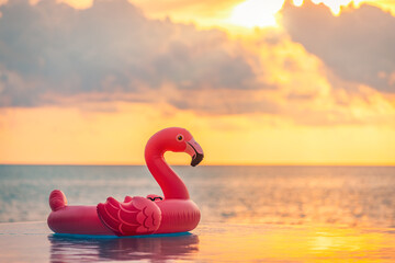 Playful summer pool scene sunset pink flamingo inflatable sea view. Fun happy vacation vibes perfect for tropical relaxation colorful water background. Joyful beach travel tourism decoration copyspace