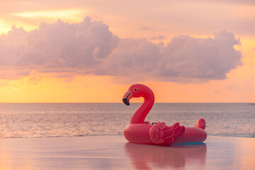 Playful summer pool scene sunset pink flamingo inflatable sea view. Fun happy vacation vibes perfect for tropical relaxation colorful water background. Joyful beach travel tourism decoration copyspace
