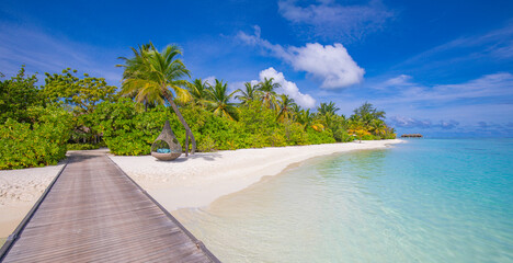 Stunning tranquil scenic Maldives paradise island long wooden jetty into tropical luxury resort. Panoramic summer vacation landscape pristine sea closeup white sand beach vibe. Sunny sky inspire shore
