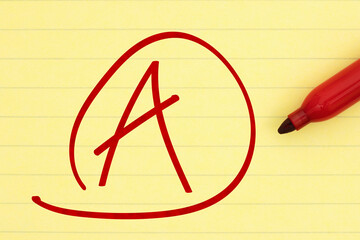 Getting a great grade with A mark with a red marker on ruled loose leaf notebook paper