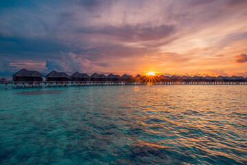 Stunning Maldives water villas sunset breathtaking sea bay view. Amazing summer landscape luxury travel vibes. Tranquil picturesque beach tourism romantic tropical escape. Couple honeymoon destination