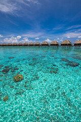 Stunning Maldives water villas wooden pier over turquoise sea bay picturesque summer landscape. Amazing luxury travel tropical beach vacations. Honeymoon tourism destination paradise, sunny blue sky