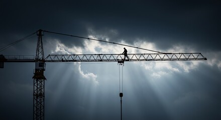 Silhouette of a construction worker on a crane against a dramatic sky