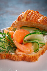 Croissant sandwich with smoked salmon cucumber and dill filling