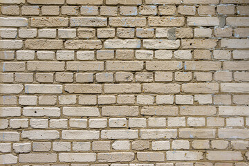 A boring wall of gray silicate bricks. Neutral building background of degradation.