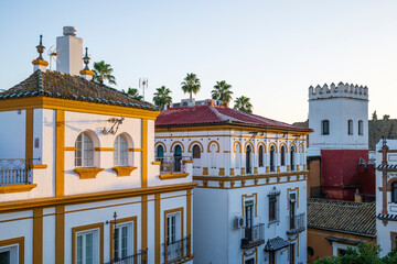 Typical architecture of Seville, Andalusia, Spain.  The warm colours of the setting sun illuminate the top of the buildings with a gentle glow