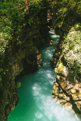 Turquoise River Flowing Through Lush Green Canyon