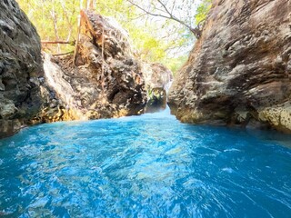 Crystal-clear blue water canyon in Costa Rica jungle