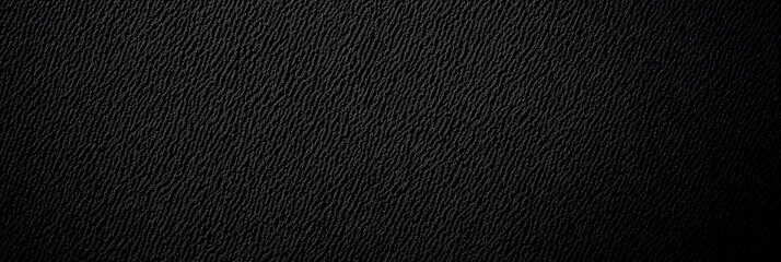 Detailed black textured surface with subtle lighting gradient, ideal as dark minimalistic background, wallpaper, abstract grunge template, or industrial design element