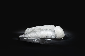 Melting Ice. A piece of melting ice on a dark background