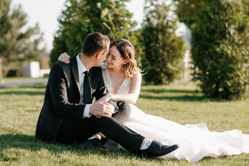 bride and groom walking in the park