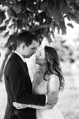 bride and groom walking in the park