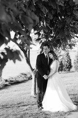 bride and groom walking in the park