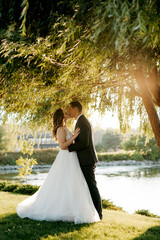 bride and groom walking in the park