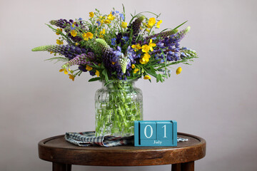 Bouquet of buttercups and lupines celebrating the first day of july