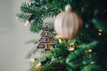 charming ornament shaped like a Christmas tree, adorned with a stack of tiny books,