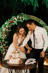 newlyweds happily cut and taste the wedding cake