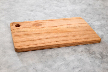 Wooden cutting board on gray background