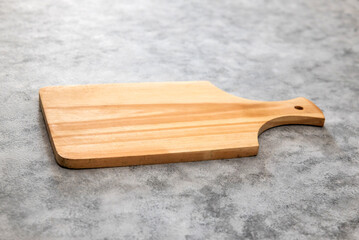 Wooden cutting board on gray background
