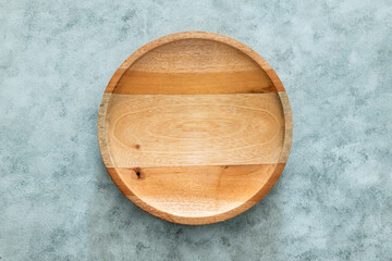 Wooden plate on gray background
