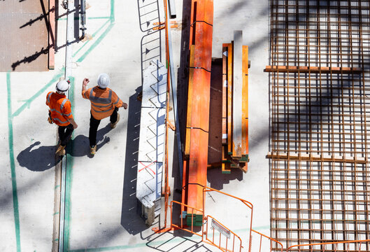 Overhead view of a construction site with construction workers having a meeting