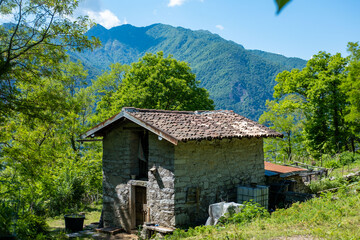 charming stone house in tranquil Italian mountain setting, ancient traditional heritage, Mysterious Mountain Retreat, Alpine Architecture European mountain villages