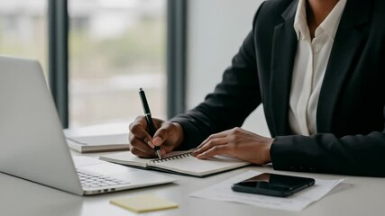 Woman in blazer taking notes - Powered by Adobe
