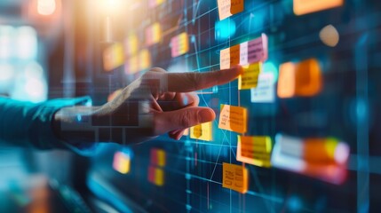 A hand interacts with colorful digital notes on a touchscreen, highlighting modern technology and collaboration in a workspace.