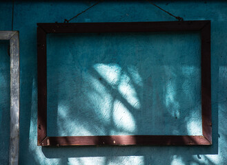 old wooden frame on   blue wall background