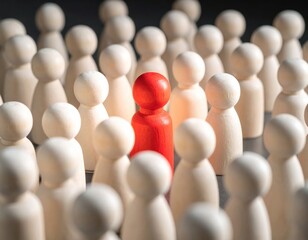 A Unique Red Figurine Stands Out Among a Group of White Wooden Figures, Symbolizing Individuality, Identity, and Distinctiveness in a Social Context